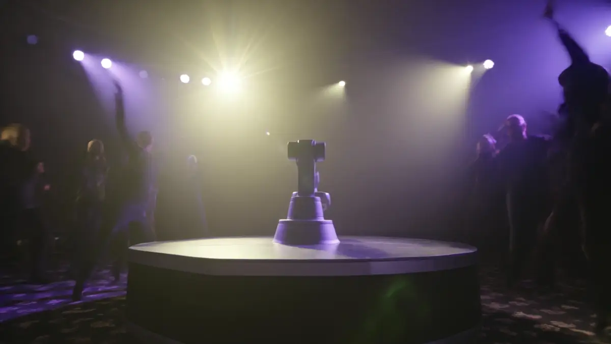360 video booth platform under gold and violet stage lights on a dance floor